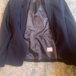 Navy blue blazer with navy blue and white stripe on the inside